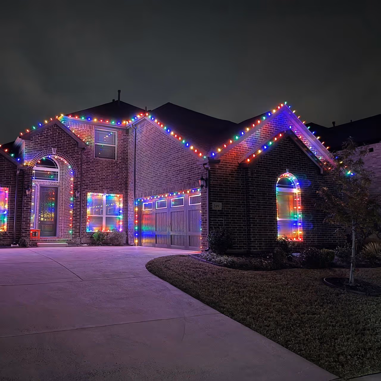 Professional Christmas light installation on residential home by JMC Lawn Care in Collin County TX