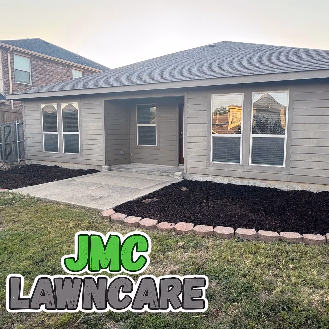 Fresh dark brown mulch installation in residential flower beds by JMC Lawn Care in Collin County TX near me