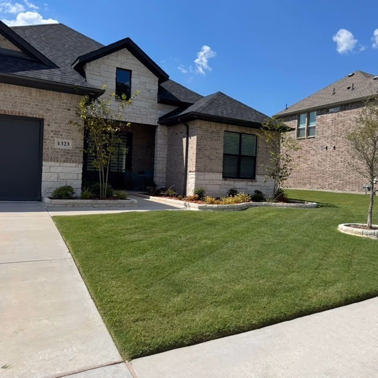 Freshly striped green lawn after professional mowing service by JMC Lawn Care in Collin County TX near me