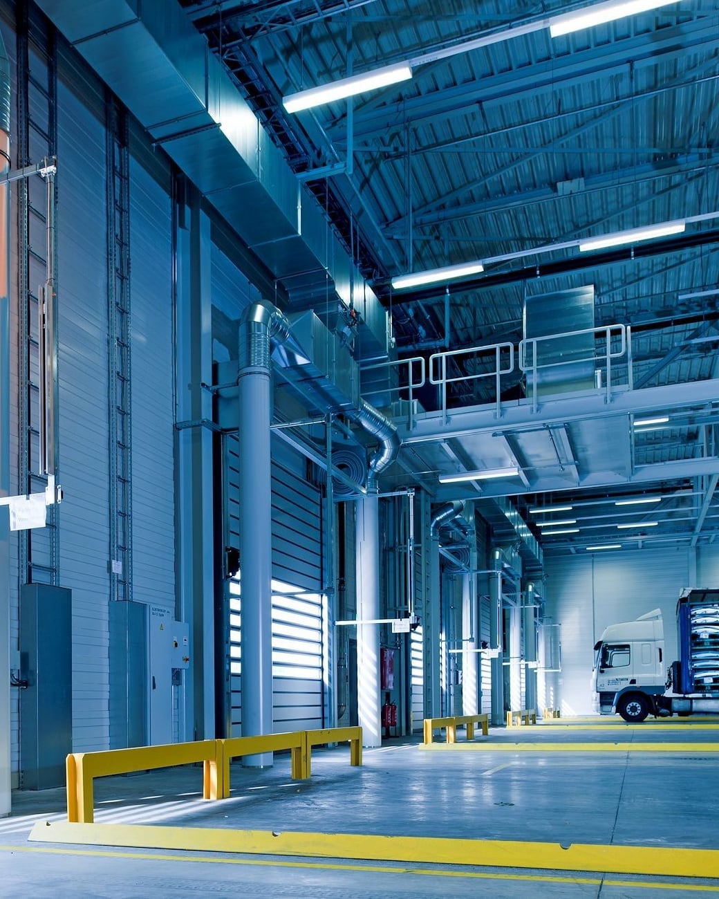 Warehouse aisle with tall racking and stacked goods