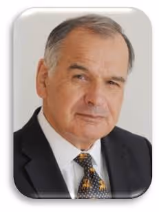 Portrait of an older man wearing a dark suit, white shirt, and patterned tie with a neutral expression.