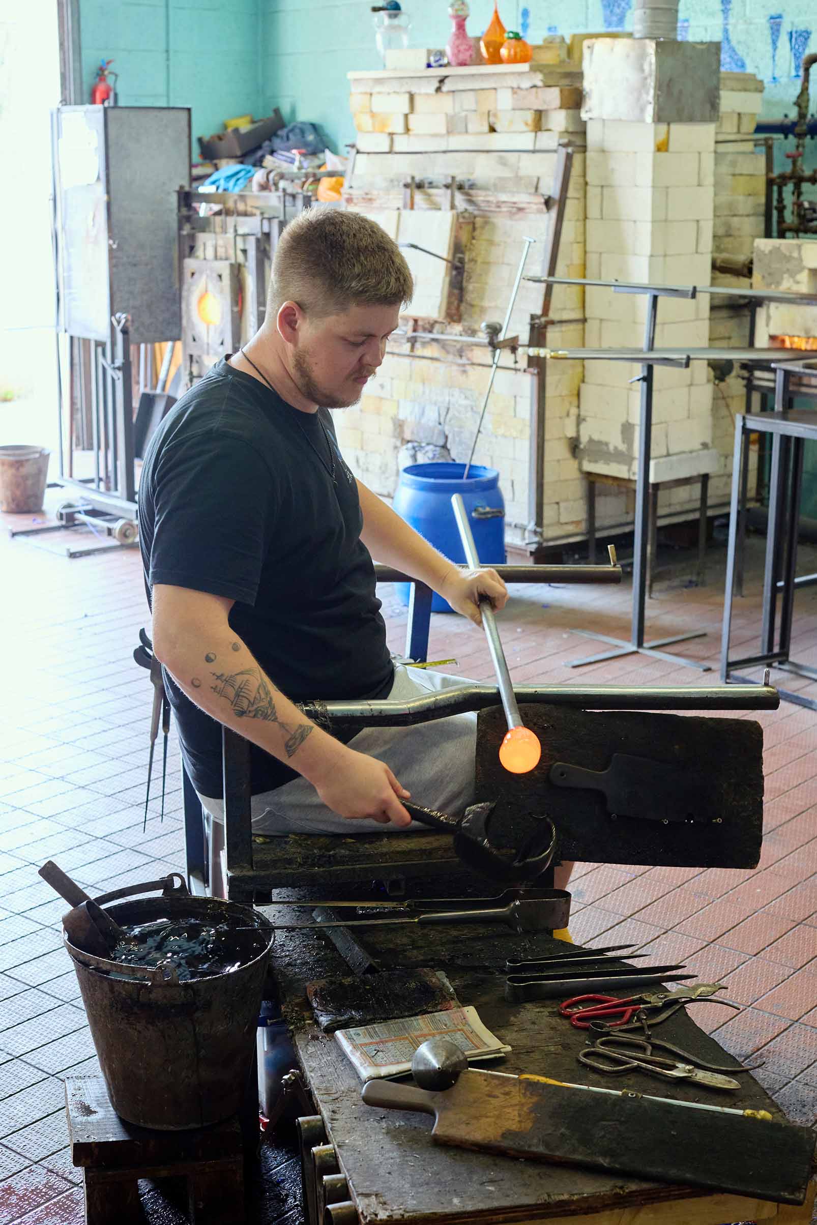 man working with molten glass at bristol blue glass