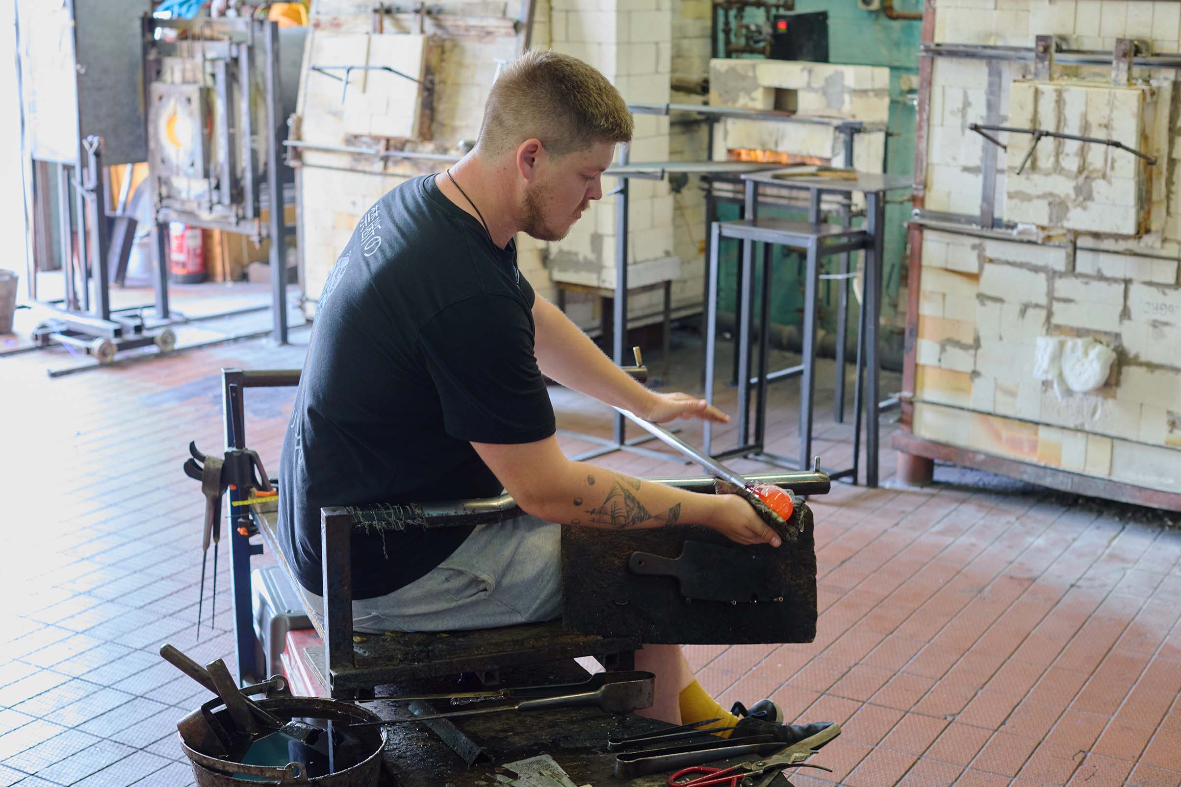 man working with molten glass at bristol blue glass