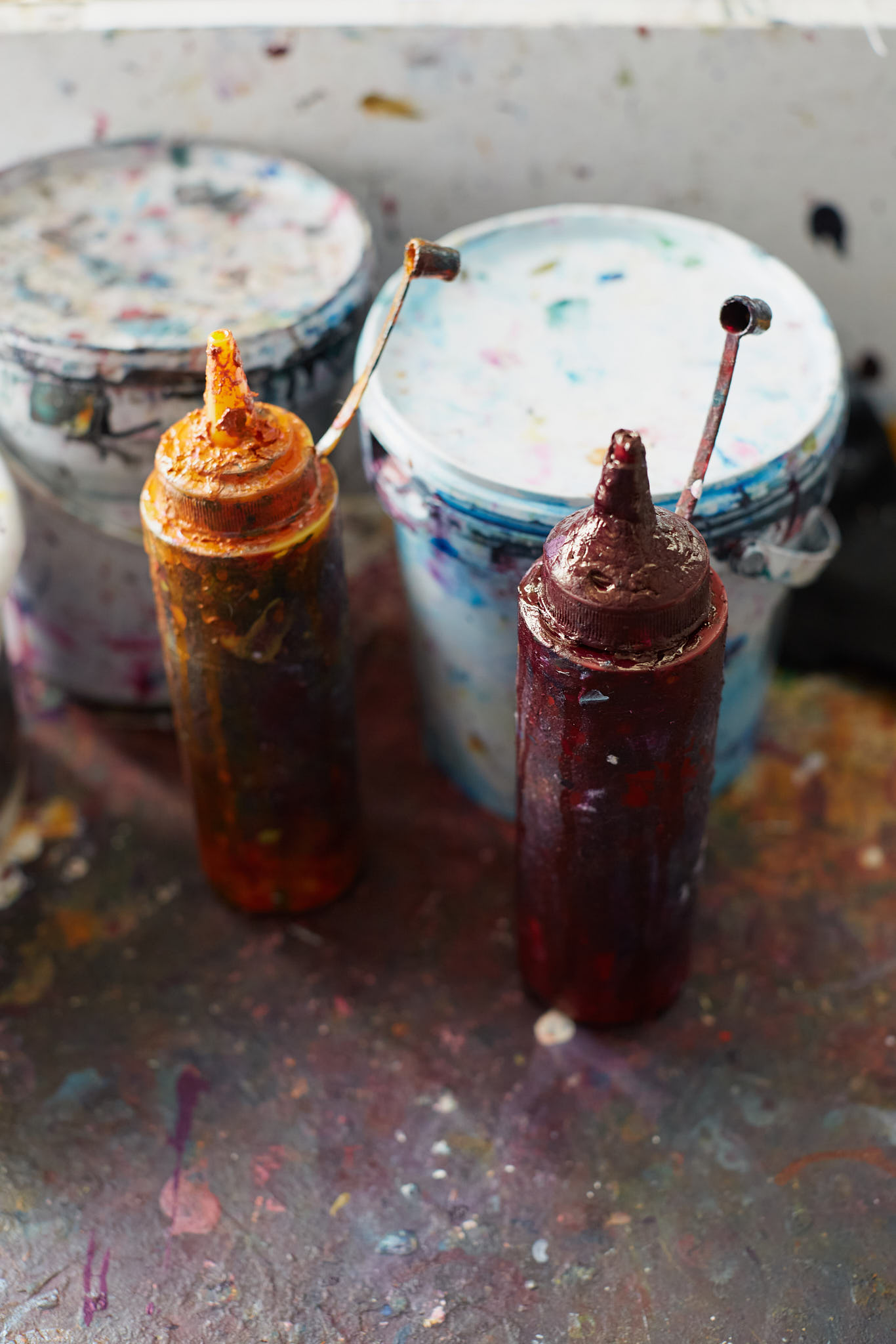 Rapture and Wright paint pots and dye bottles on floor