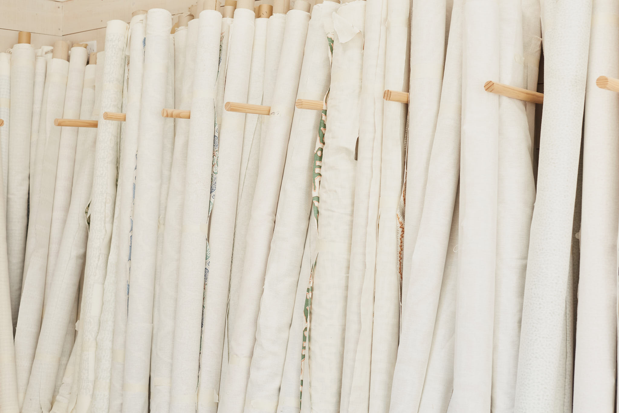 Rapture and Wright rolls of fabric leaning 