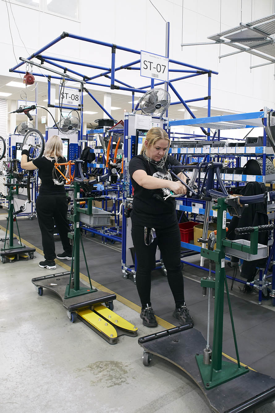 workers building bicycles at brompton bicycle factory
