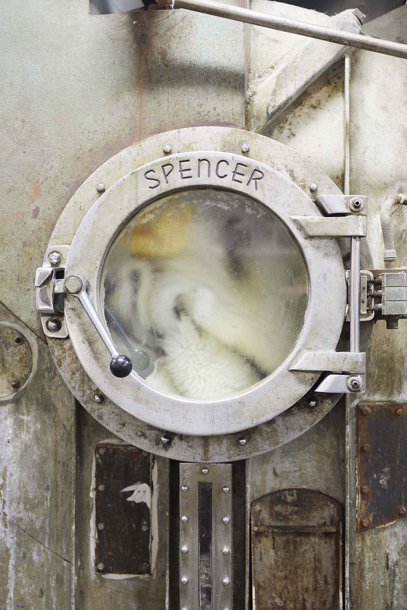 open door of large washing machine in factory devonia