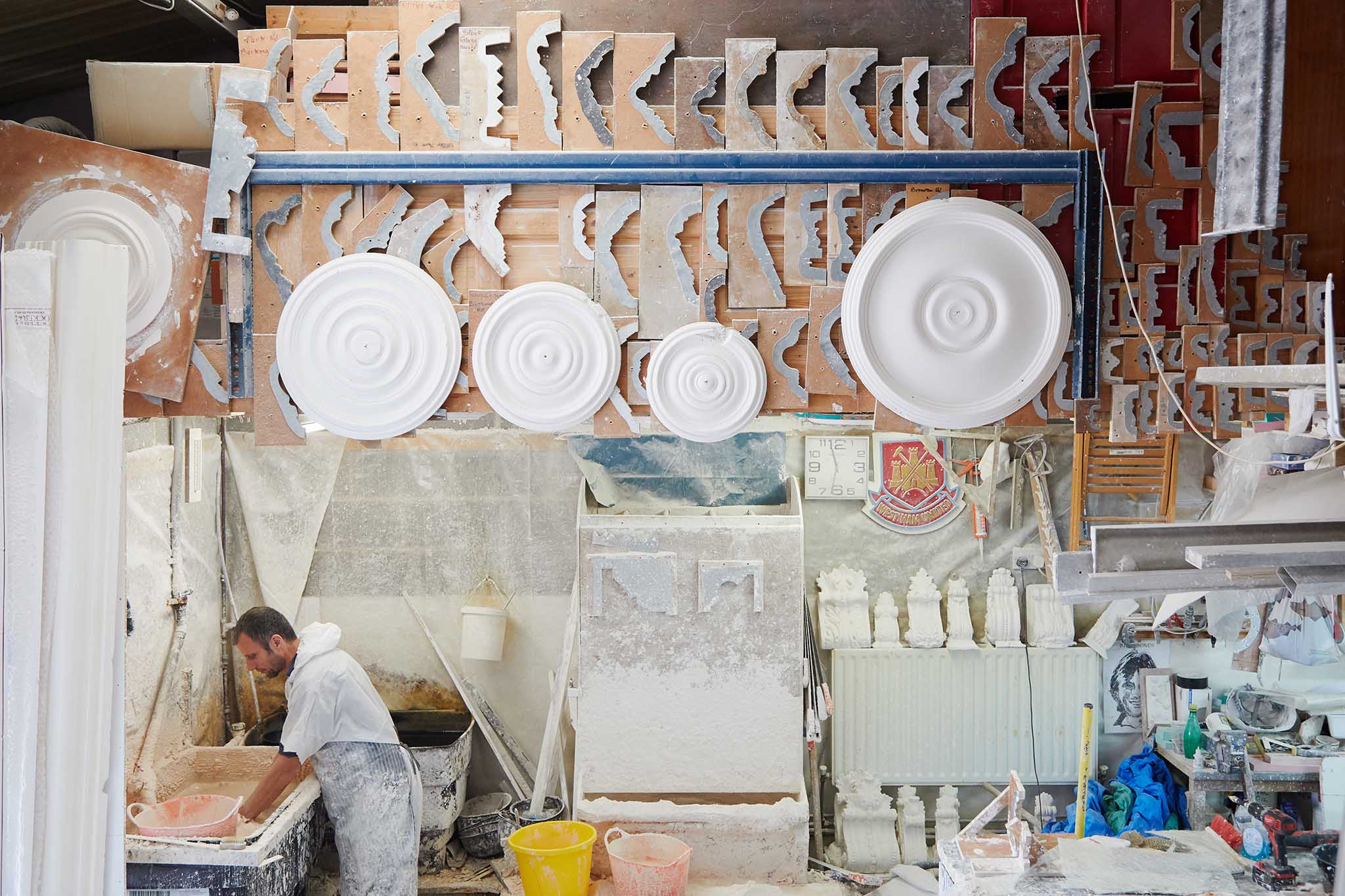 plaster ceiling centre roses hanging in factory plaster mouldings london