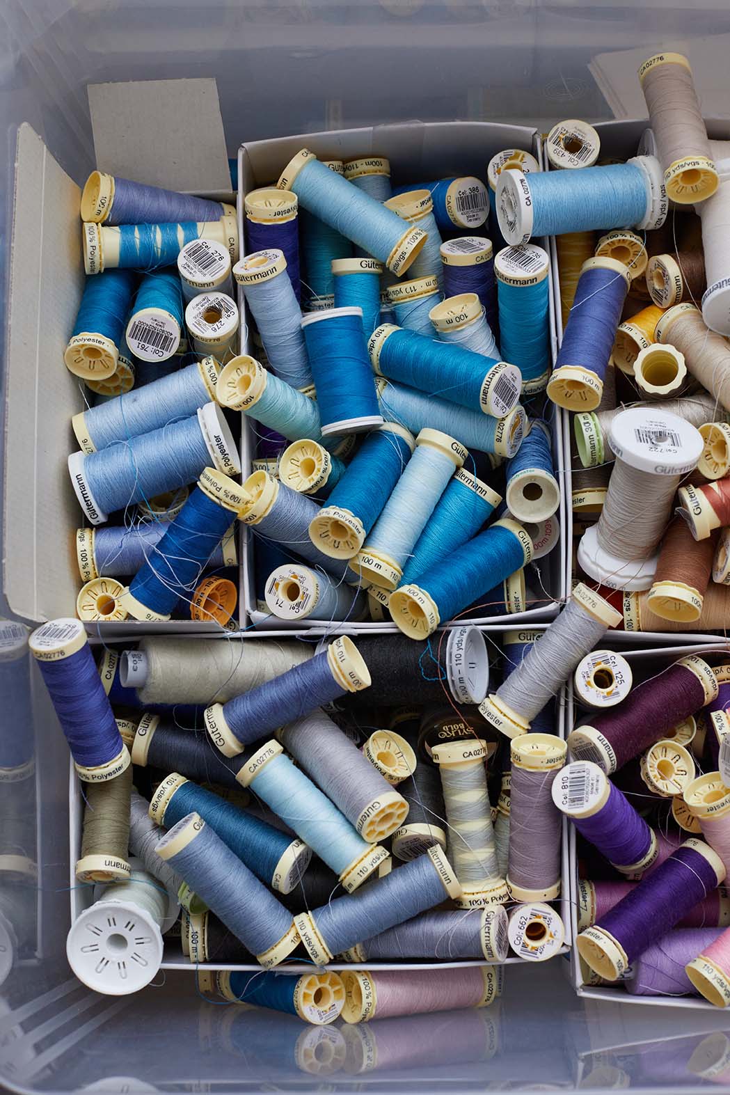 Emma Willis bespoke tailoring tray of threads rolls in multiple different shades of blue