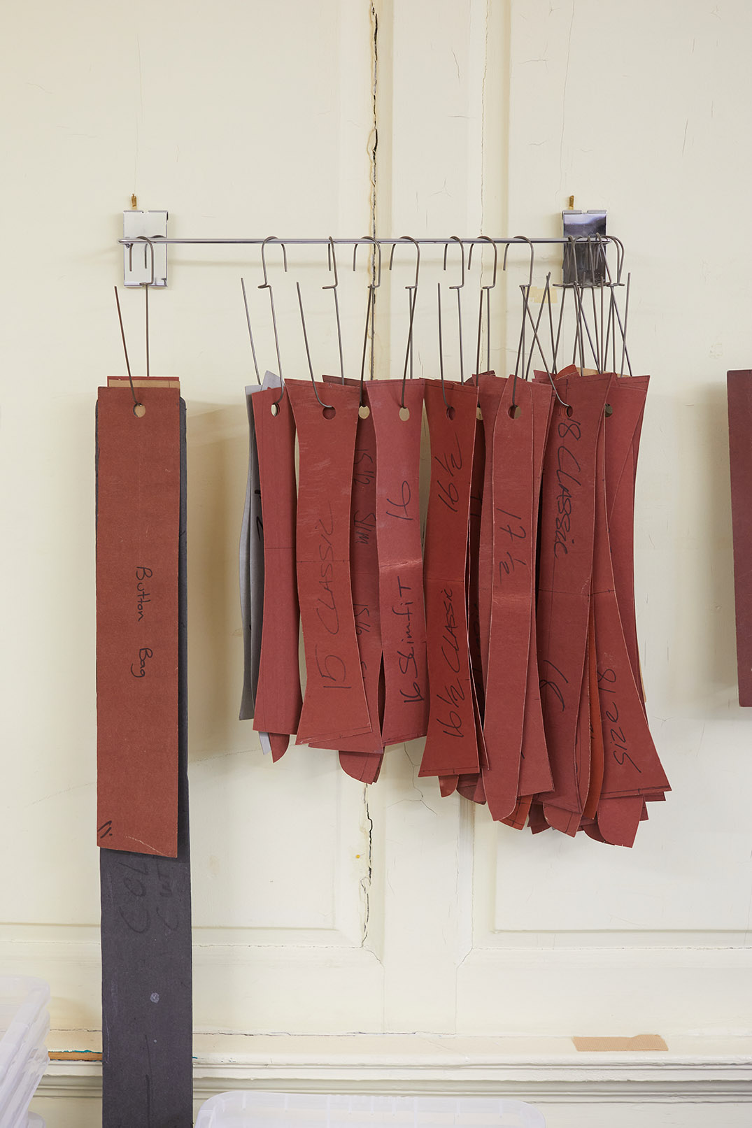 Emma Willis bespoke tailoring rust burnt orange colured fabric hanging pattern