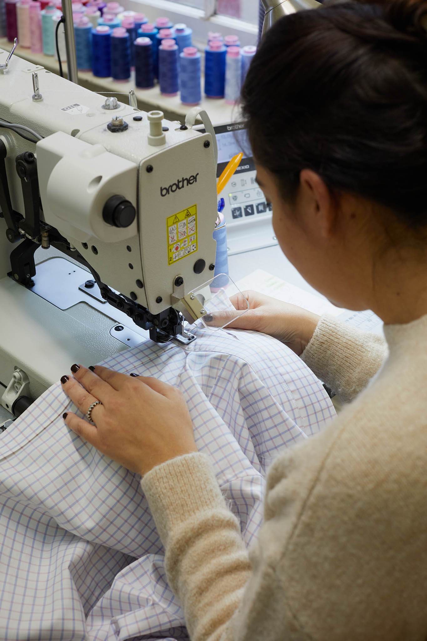 Emma Willis bespoke tailoring seamstress at sewing machine 