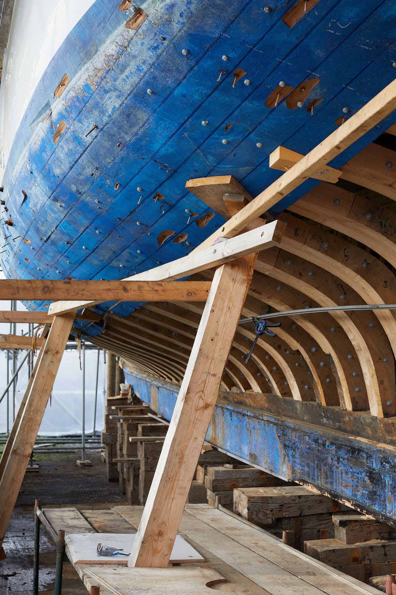 T Nielsen and Co large blue hull held up by timber supports 