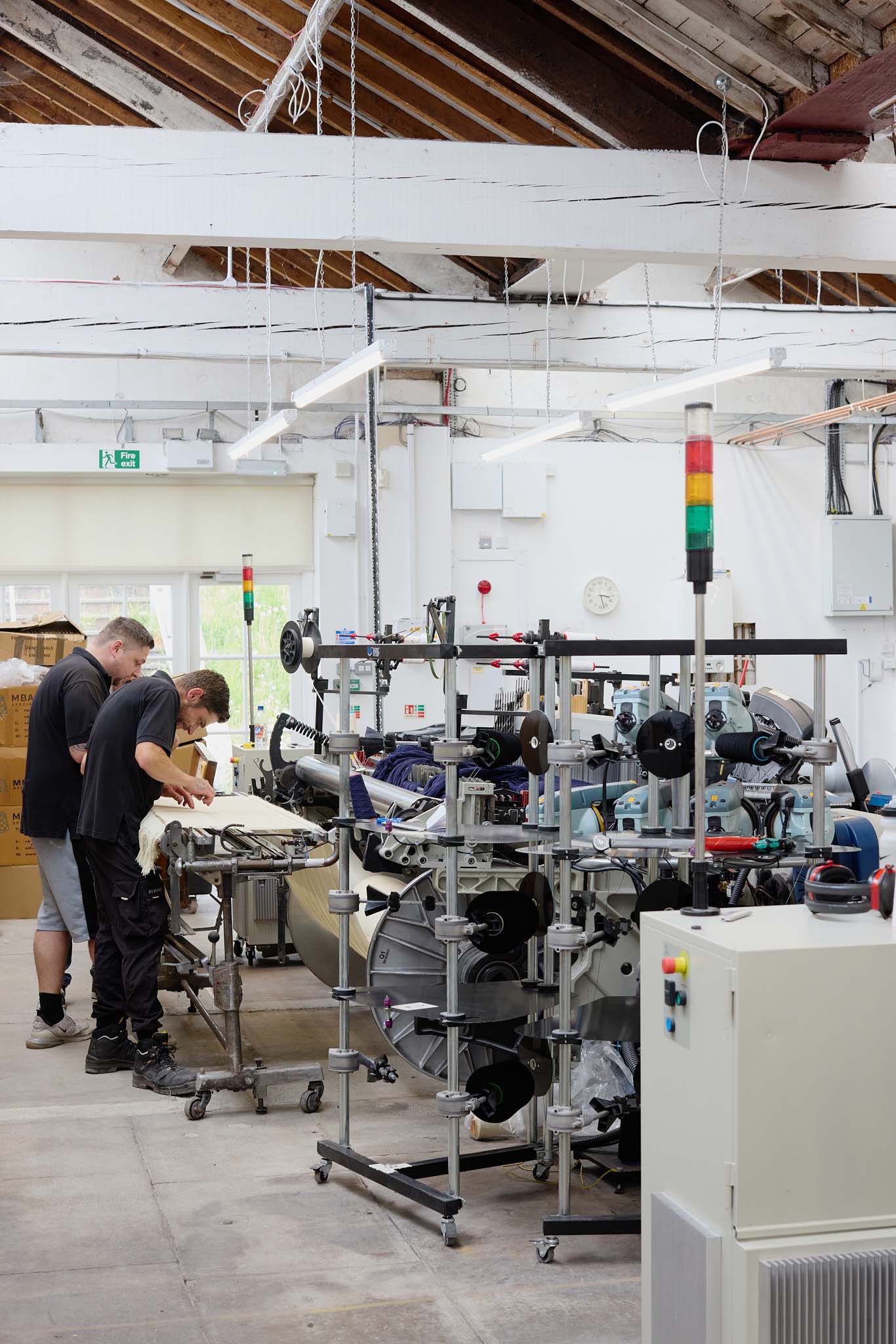 Fox Brothers workshop factory floor high wooden ceilings beams white walls and white floor 