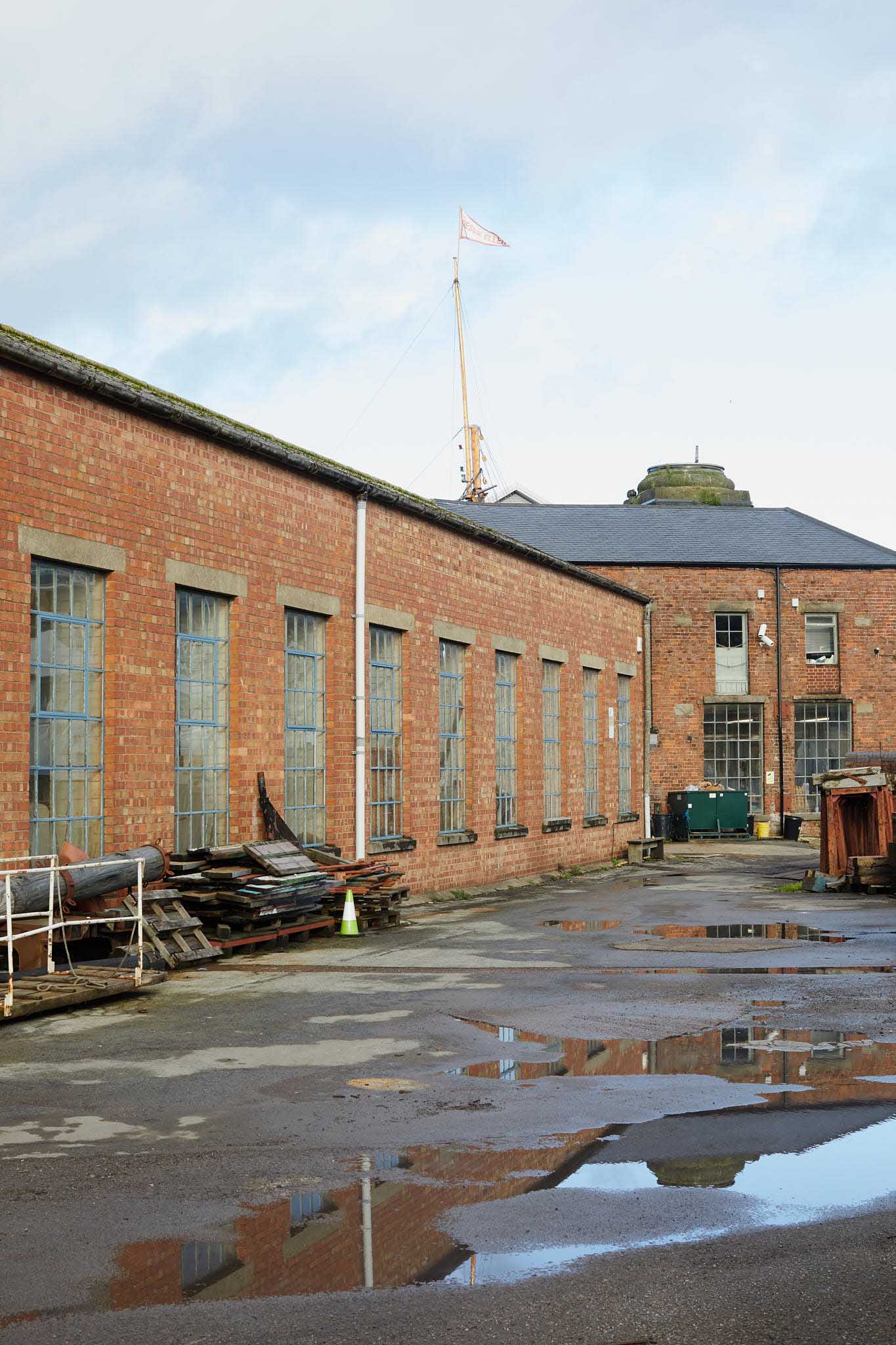 T Nielsen and Co outside red brick factory building puddles on the floor