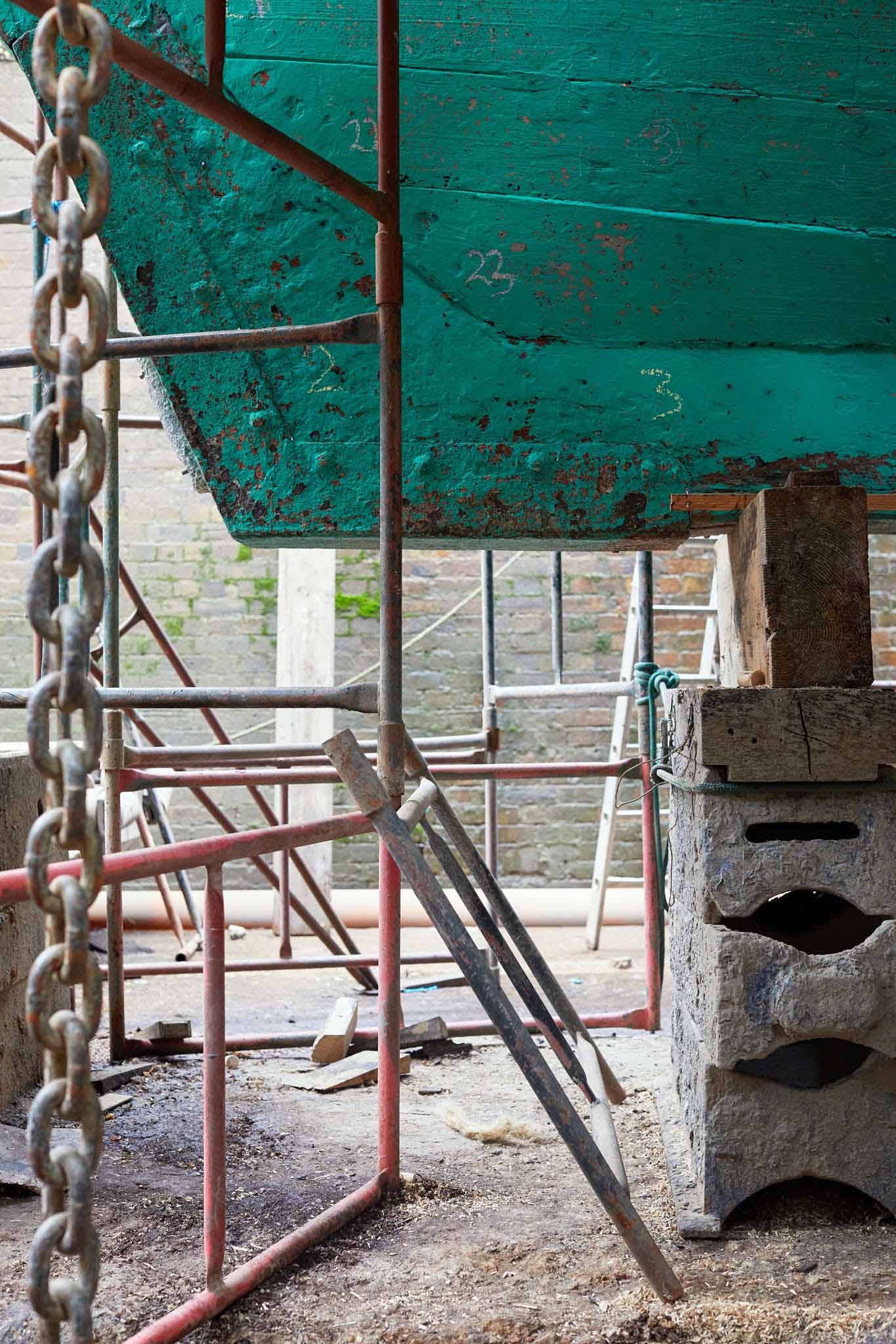 T Nielsen and Co front ships bow teal in colour propped up on steel blocks
