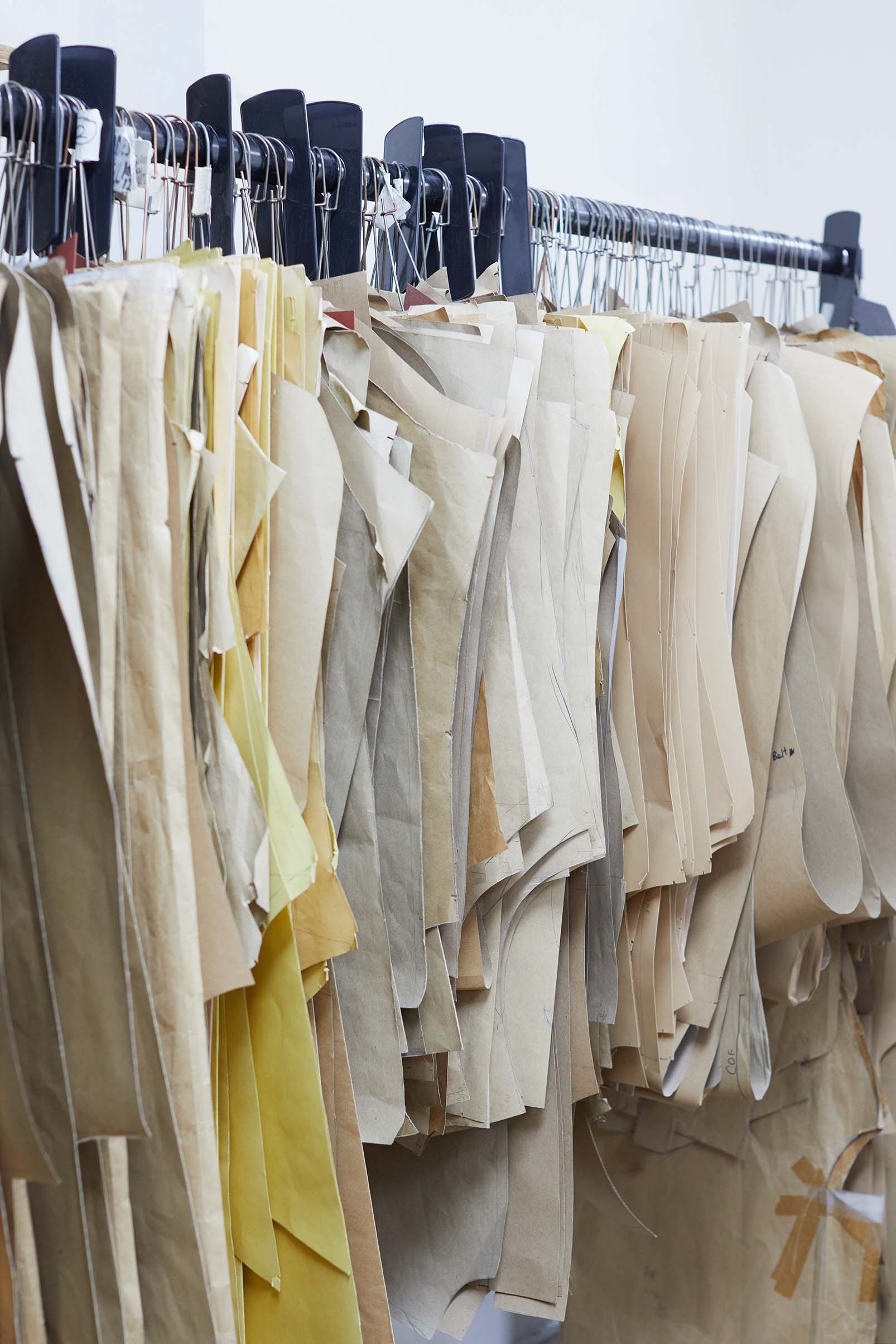 Emma Willis bespoke tailoring hanging fabric patterns cream white ecru 