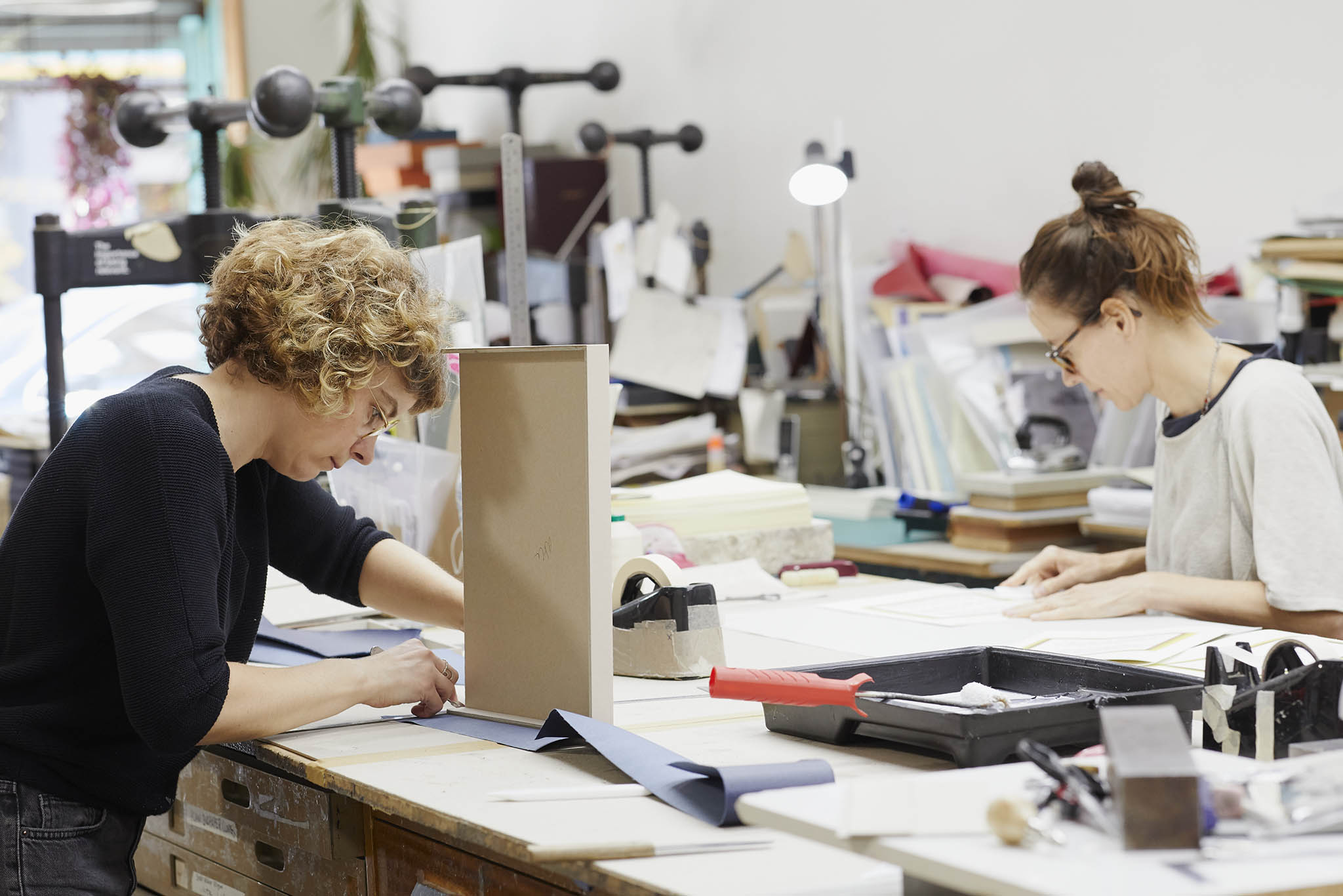 Wyvern Bindery employee working at table in workshop