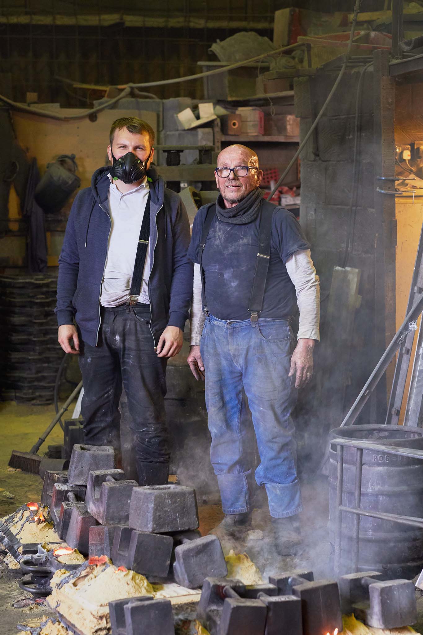 Whittons Castings two workers standing in workwear smoke steam 