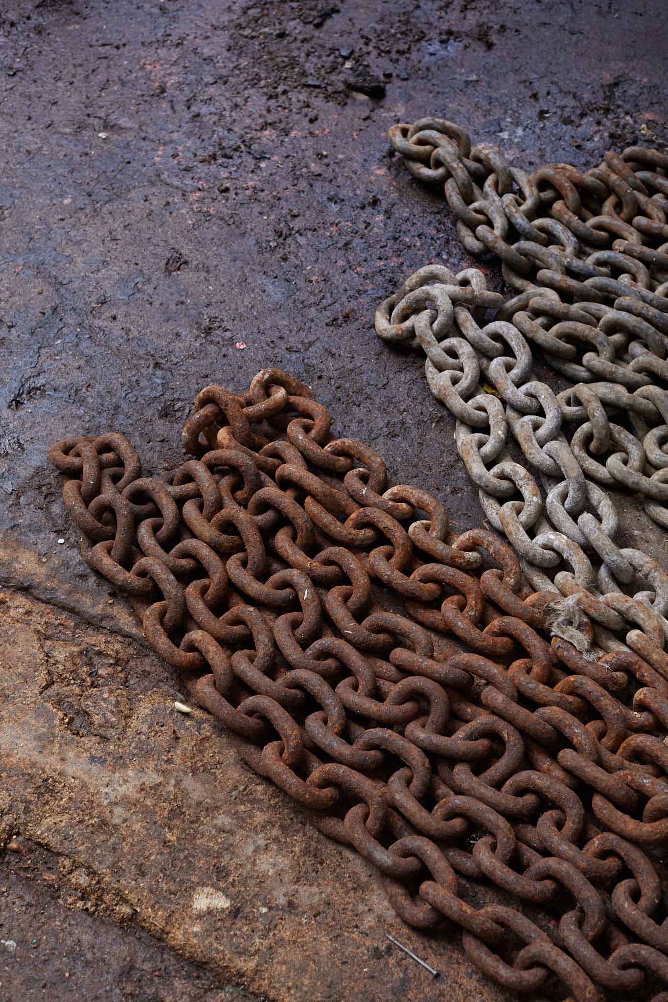 T Nielsen and Co chains lying on the floor some are rusty 
