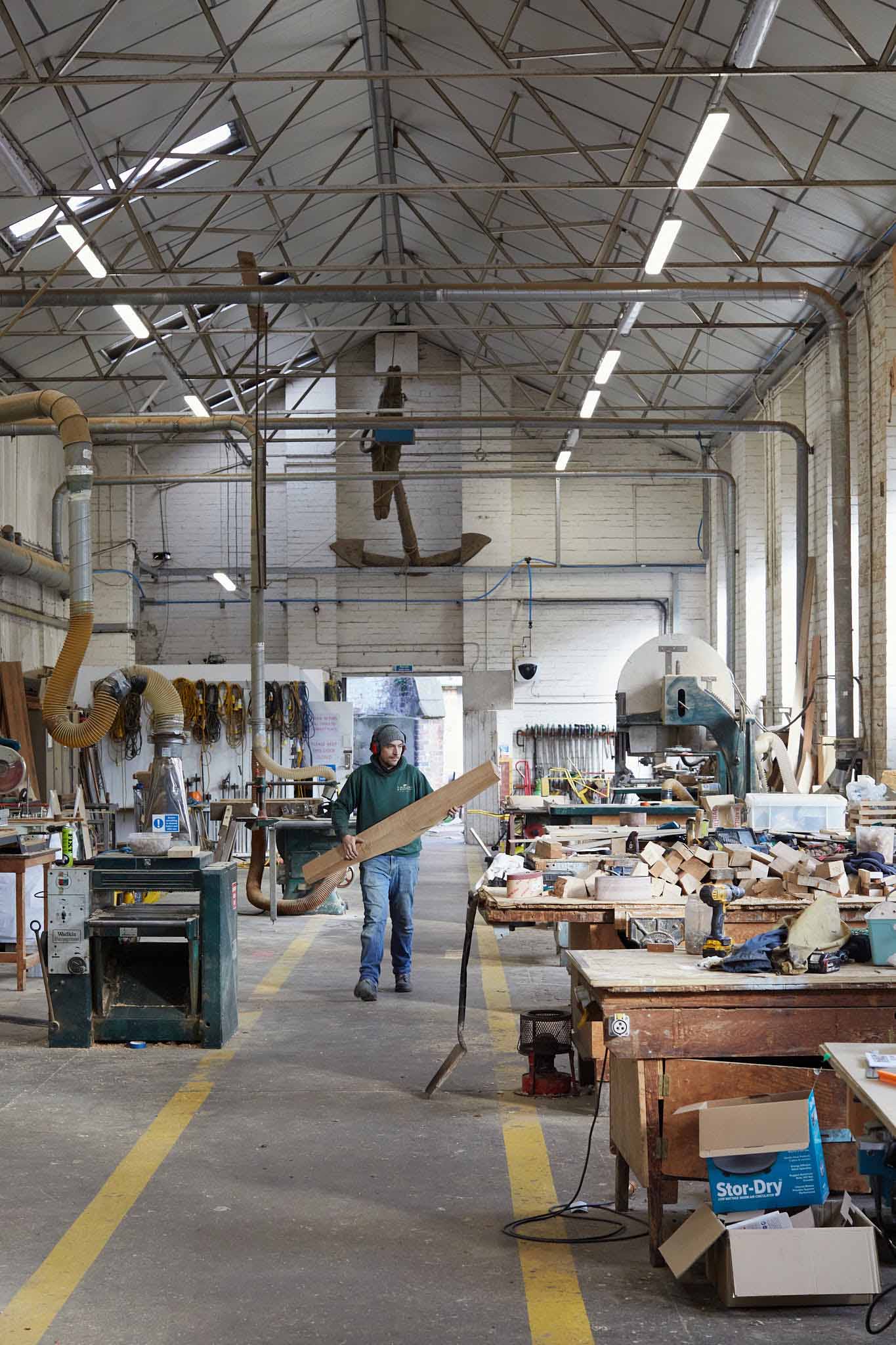 T Nielsen and Co factory floor with high white ceiling tables full of timber on the right