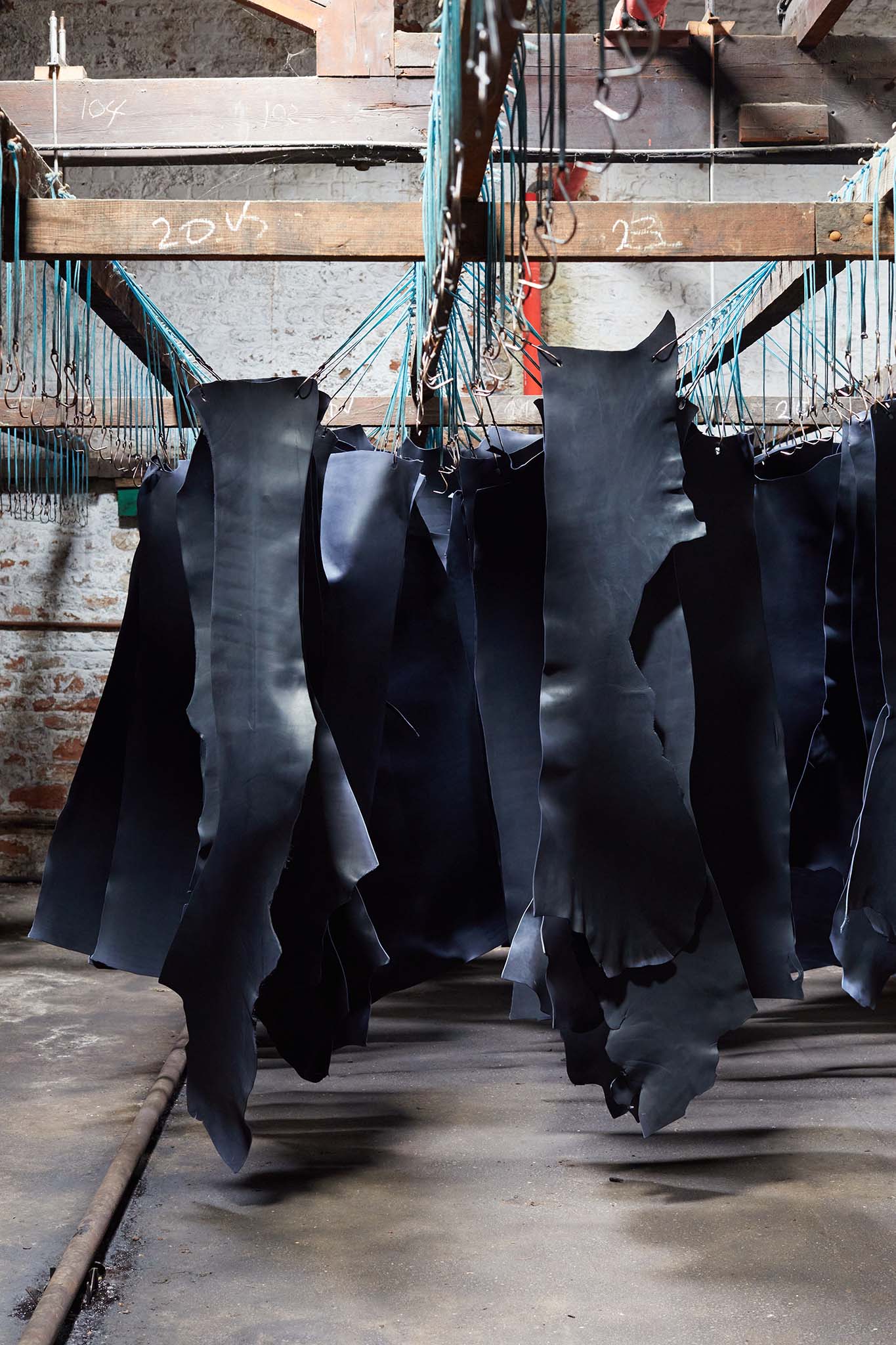 Thomas Ware and Sons hanging black leather drying in factory