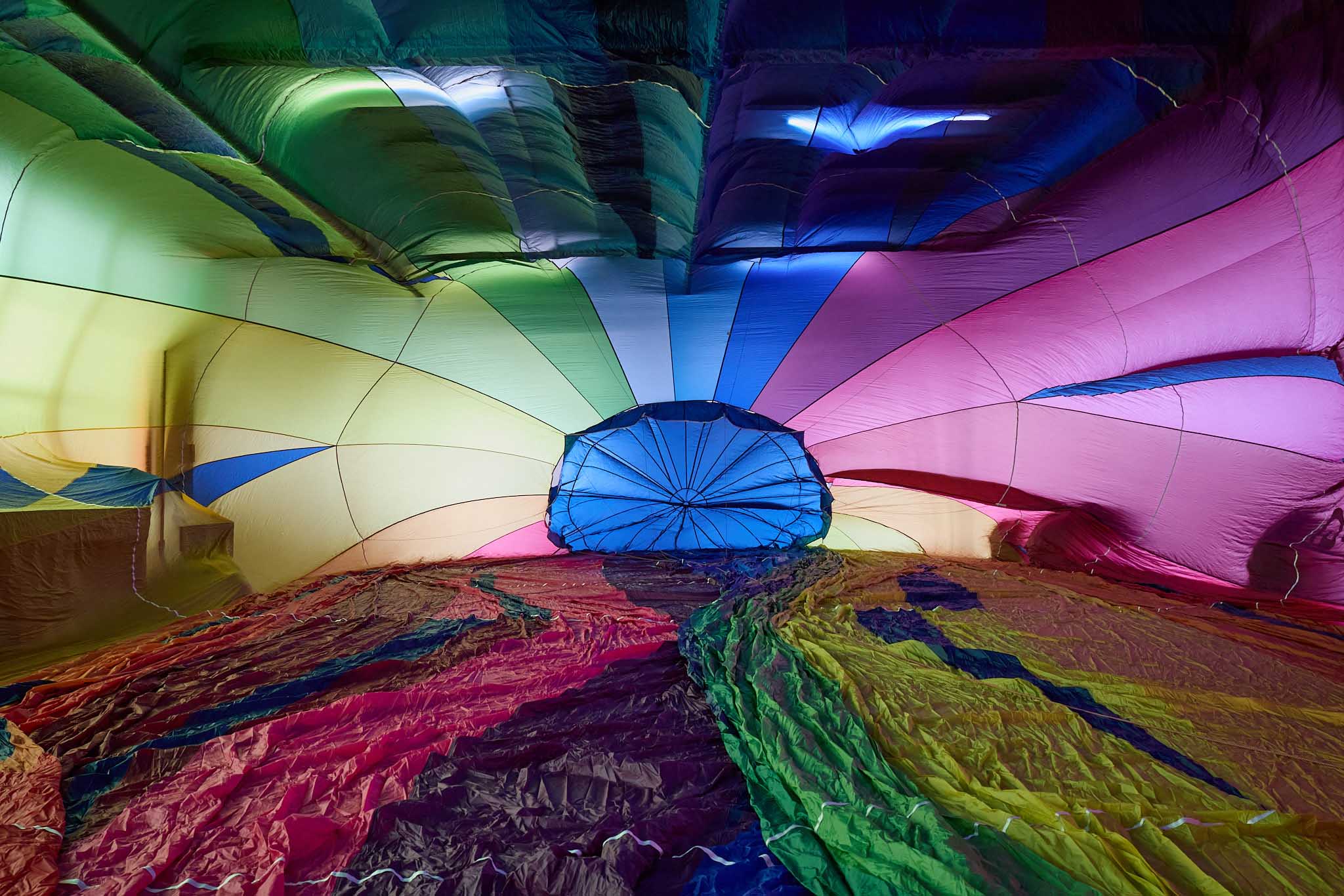 Cameron Balloons inside of partially inflated multi coloured hot air balloon