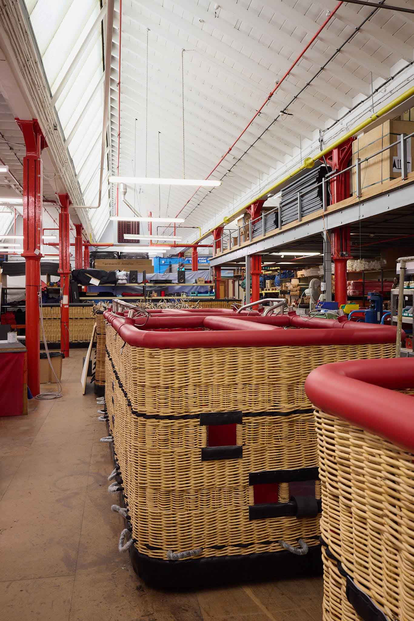 Cameron Balloons inside factory row of hot air balloon baskets