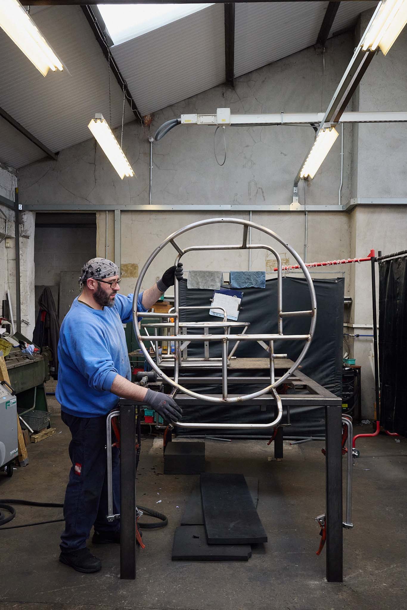 Cameron Balloons man inside factory working with metal