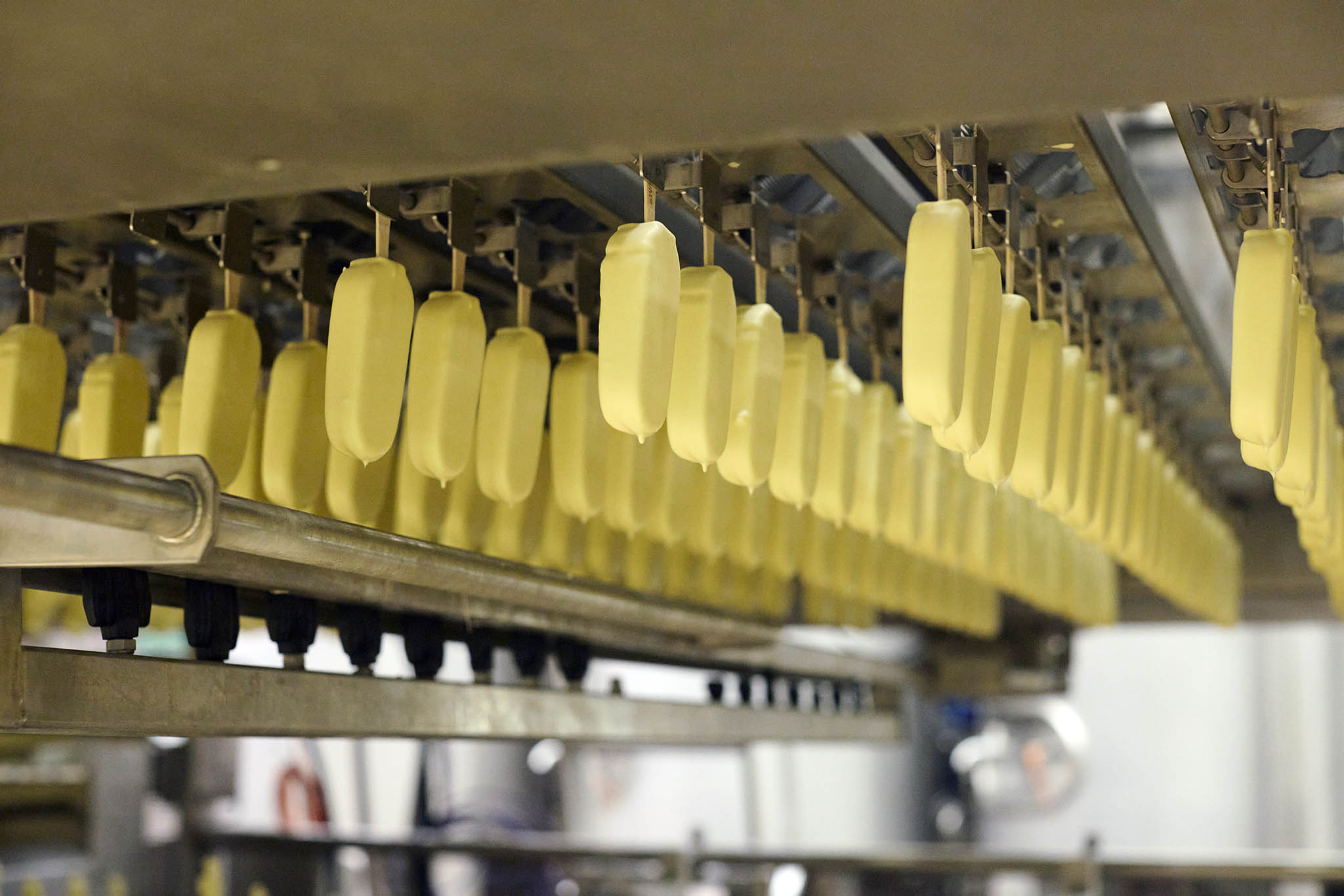 Walls Ice Cream rows of white chocolate ice cream lollies hanging upside down 