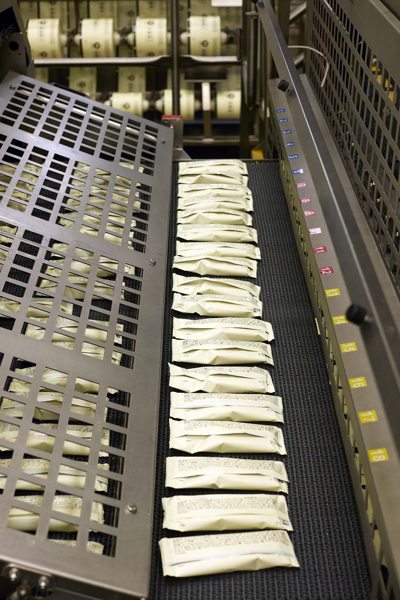 Walls Ice Cream magnum lollies on production line completed in plastic packets