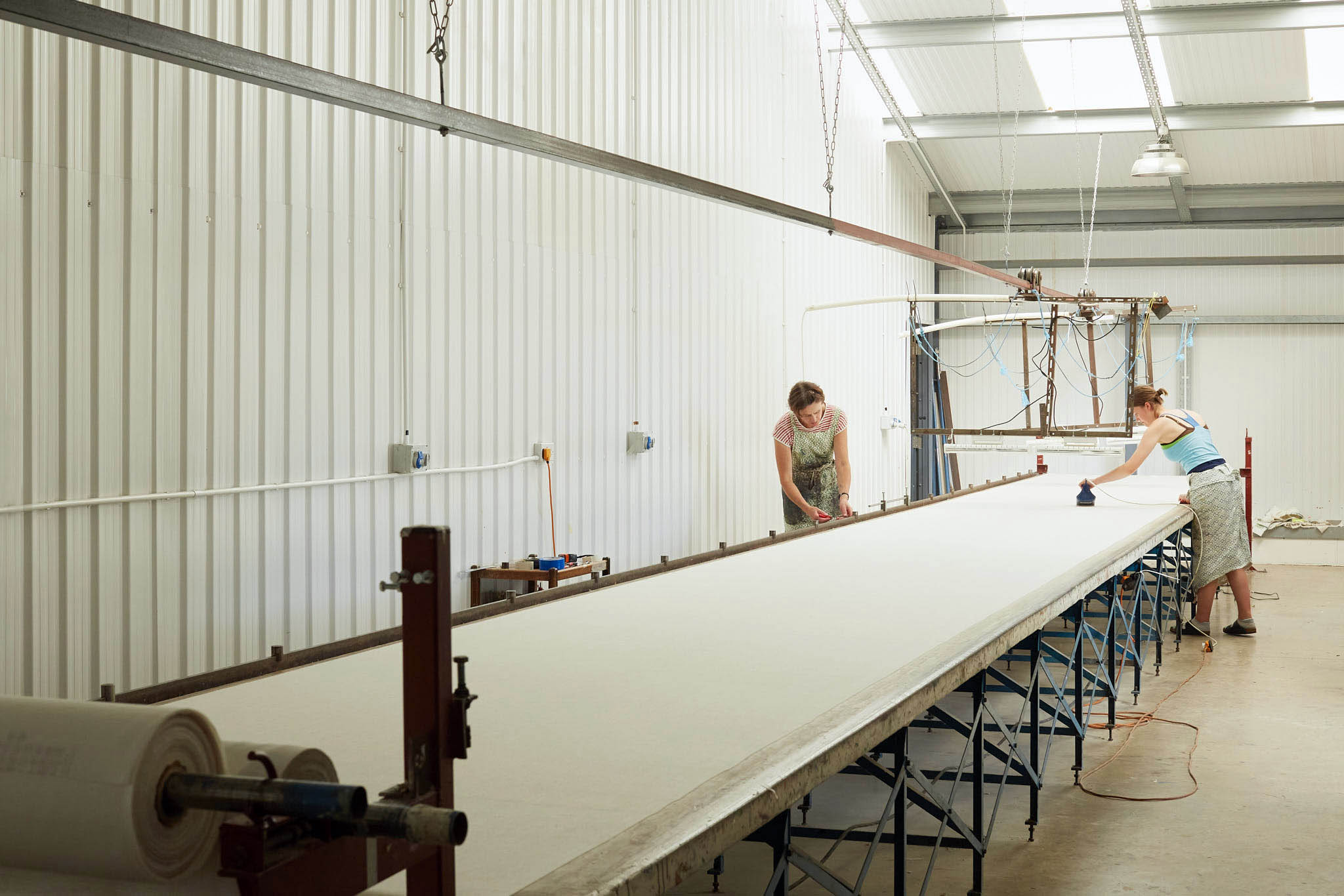 Rapture and Wright very long table inside of factory 
