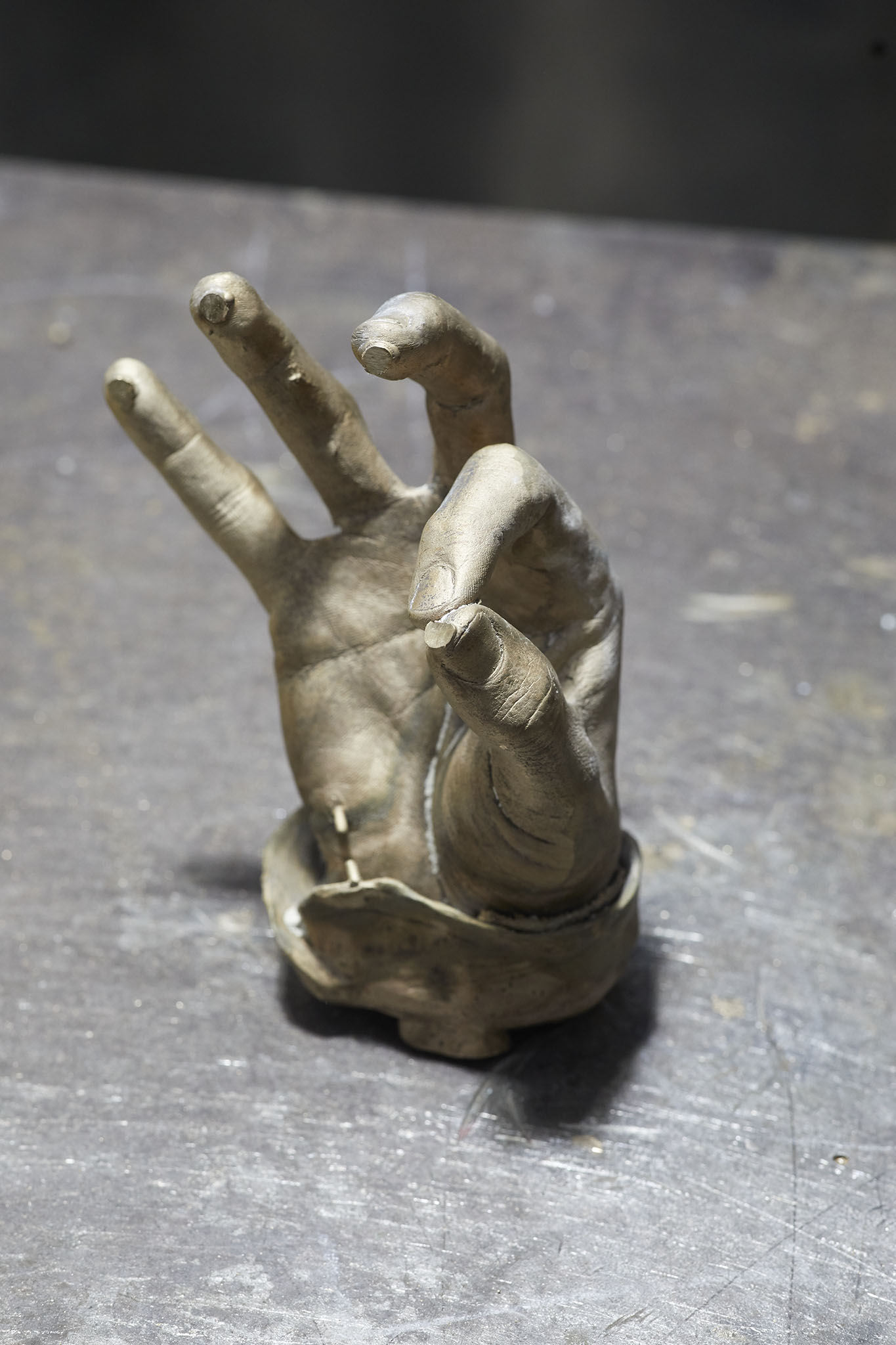 Cox London sculpture of hand on table
