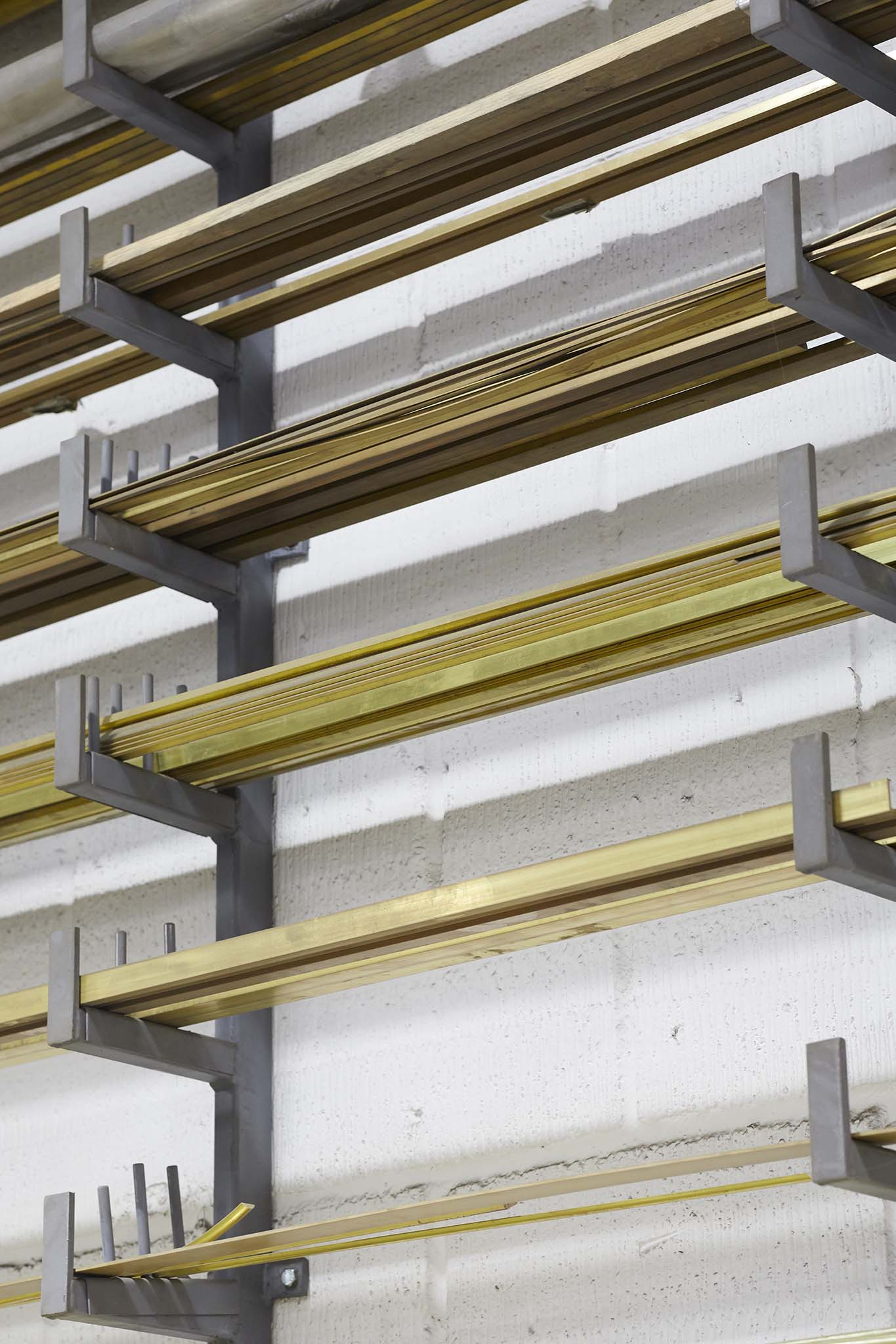 Cox London metal shelving with rods of different coloured metals