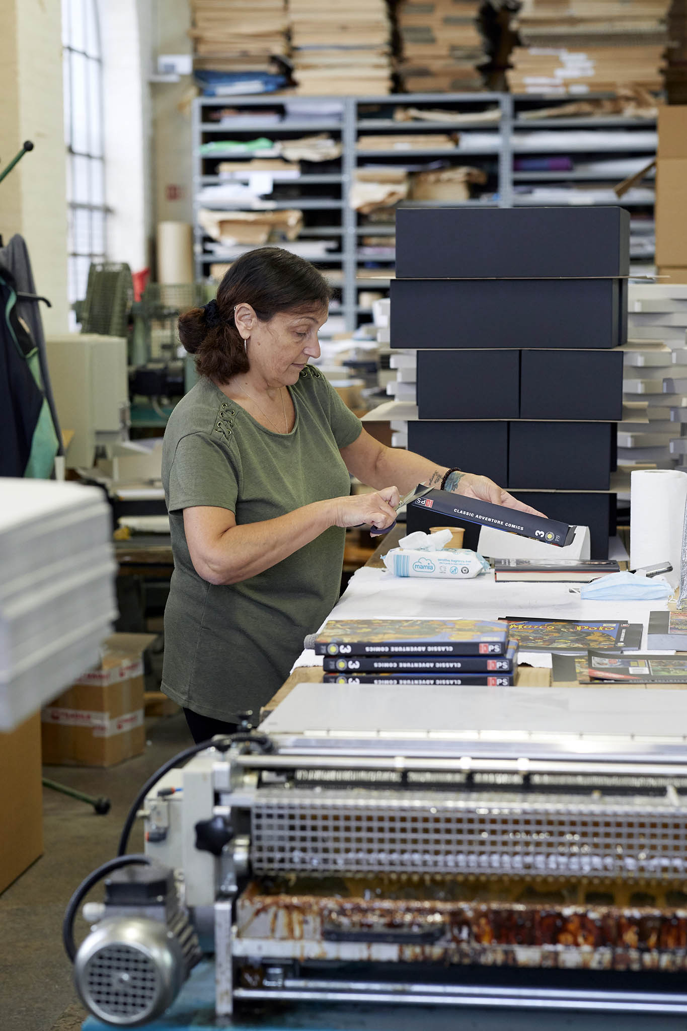 W MacCarthy & Sons woman in green tshirt at worktable assembling cardboard presentation boxes