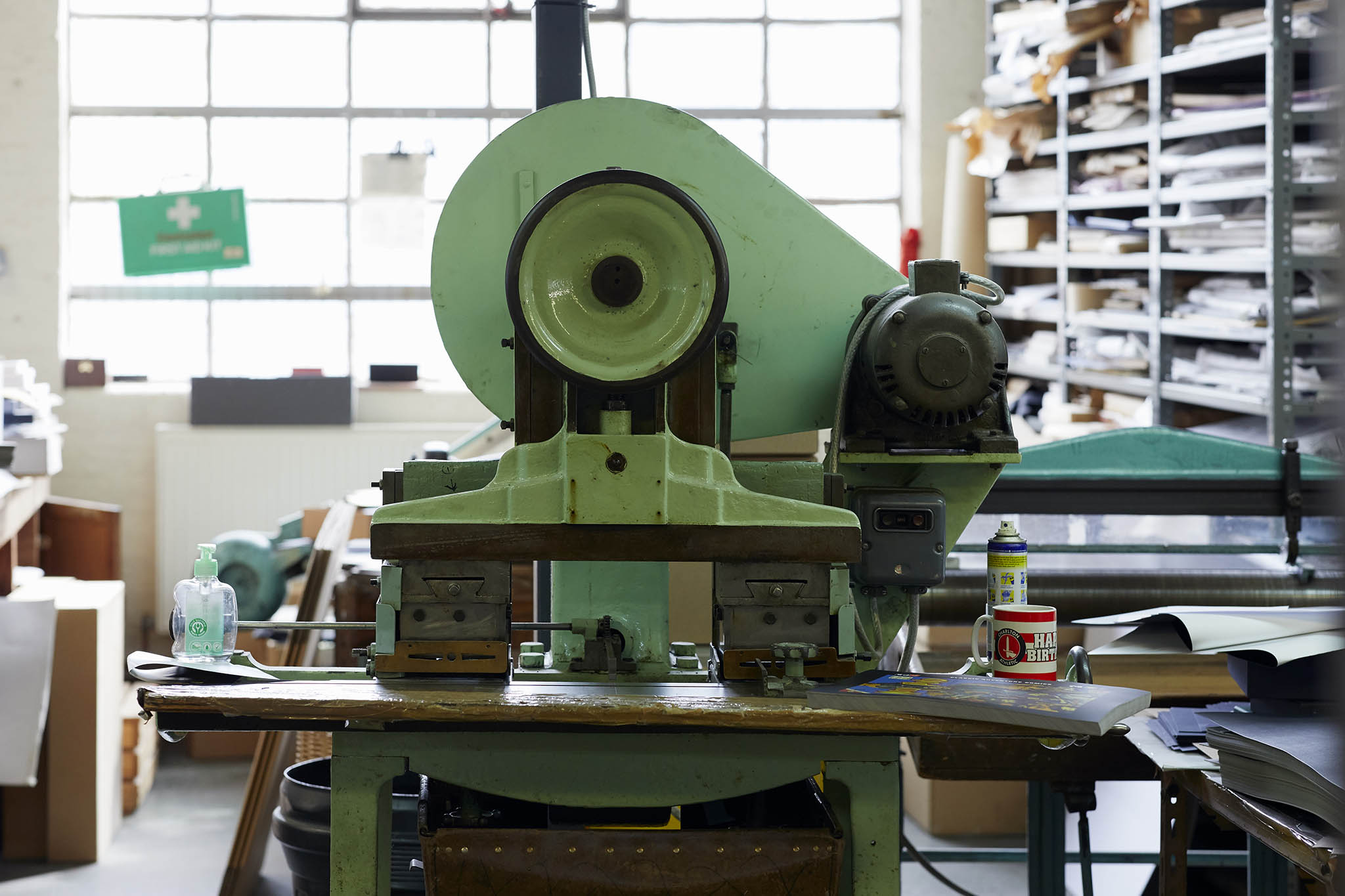 W MacCarthy & Sons large green machine in centre of image  shelves to the right stacked full of paper
