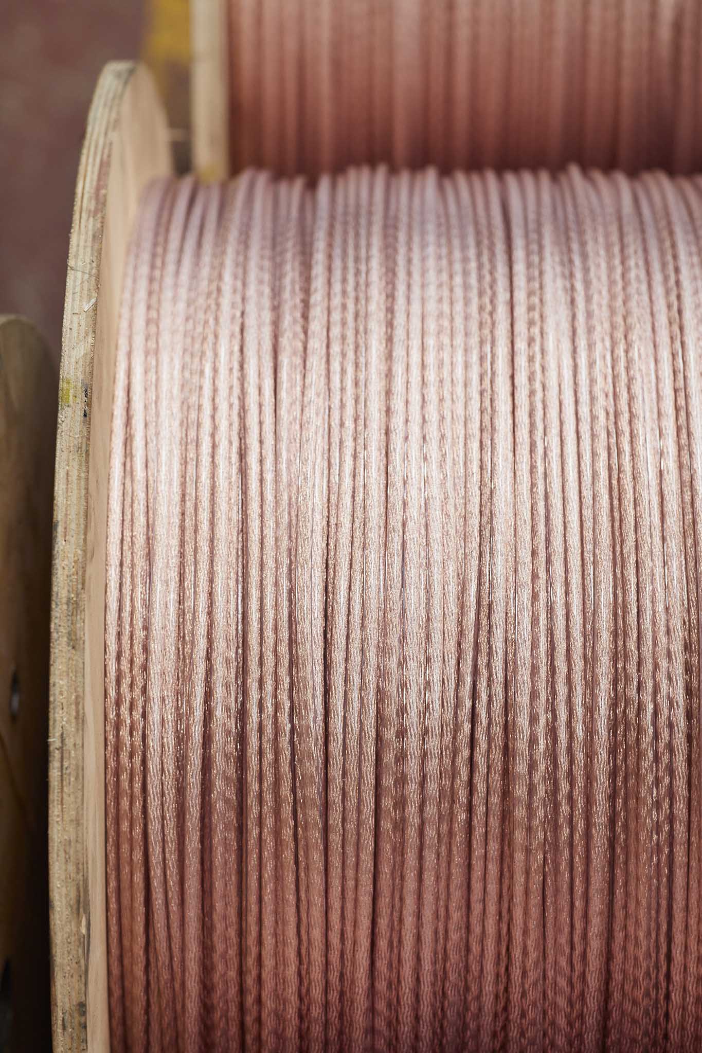 Ormiston Wire close up image of very large roll of copper shining wire in factory 