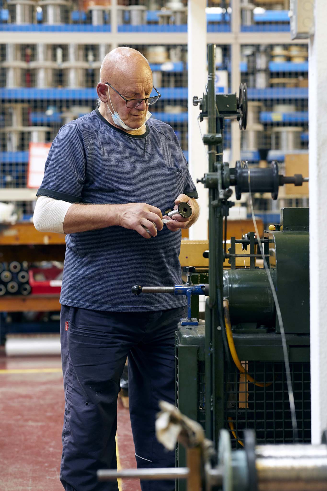 Ormiston Wire employee standing at green metal machine 
