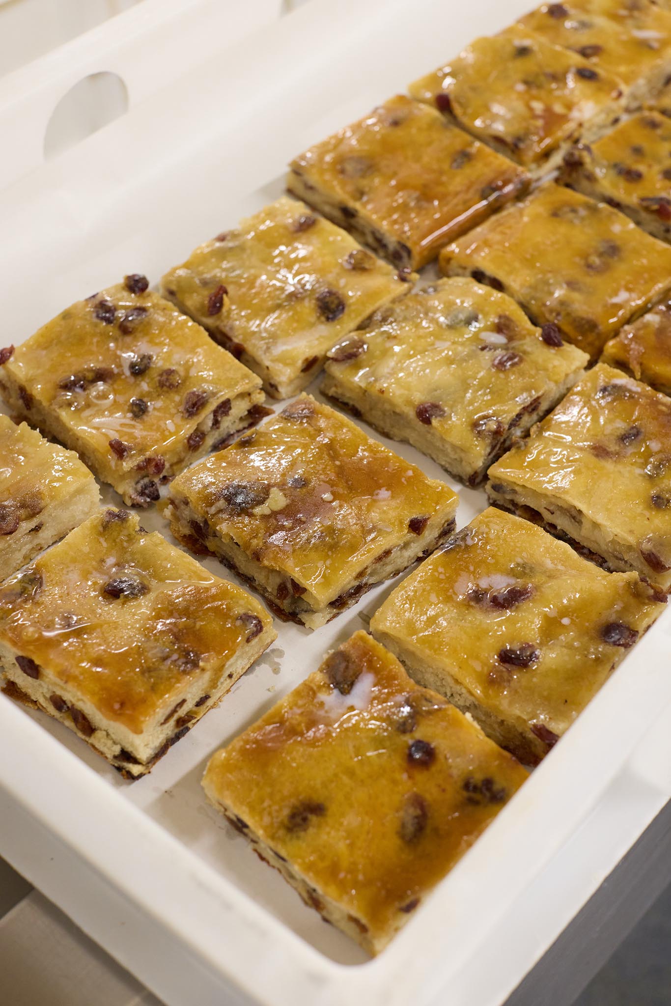 Janes Pantry tray of cooked pastry bread cake dotted with raisins currents
