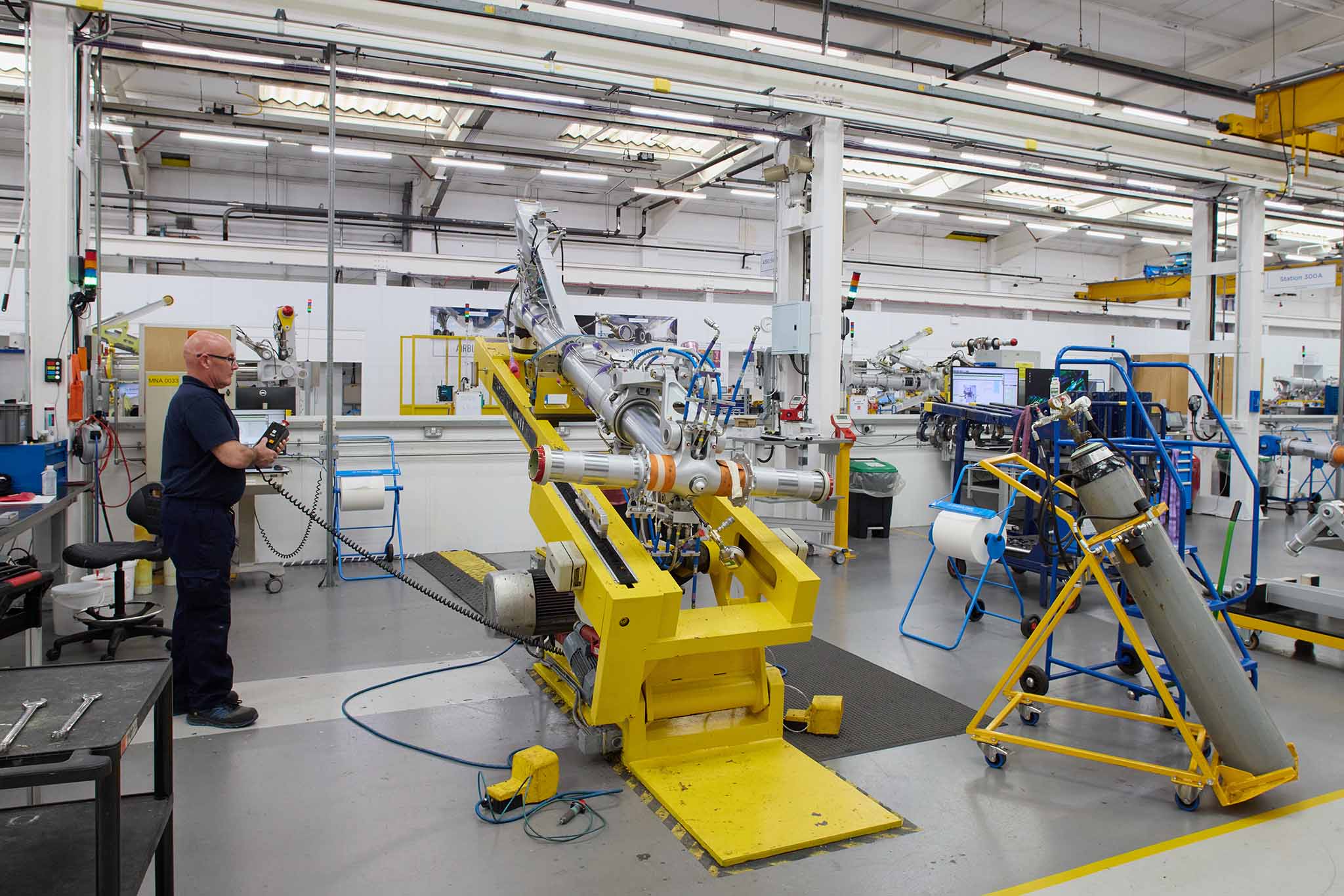 Safran Landing Systems large factory floor with various machines yellow silver high ceiling s