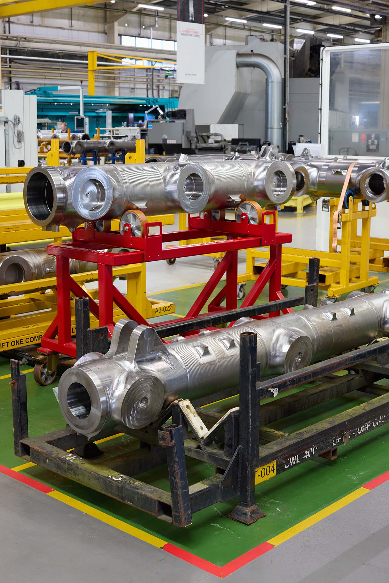 Safran Landing Systems inside factory building red yellow metal machinery silver steel pipe