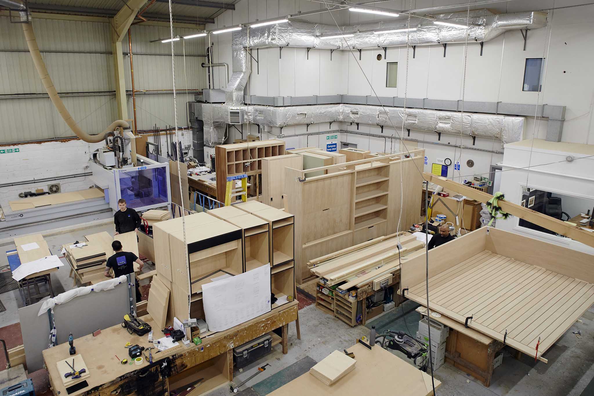 Beck workshop from above showing employees and multiple large wooden structure in the process of being built