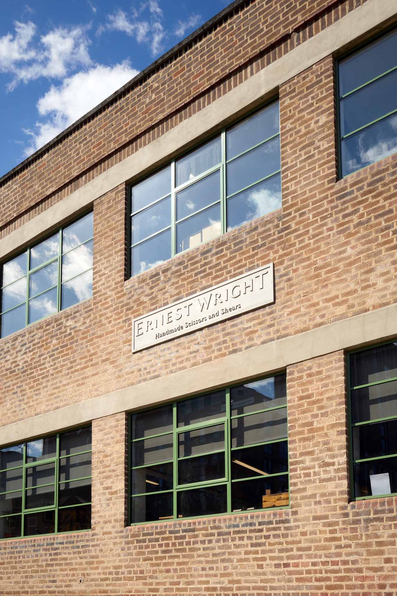 Ernest Wright red brick outside of factory building six large windows