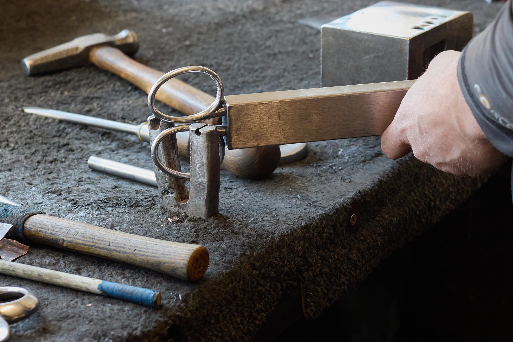 Ernest Wright scissor and blade making tools on table covered in dark grey felt