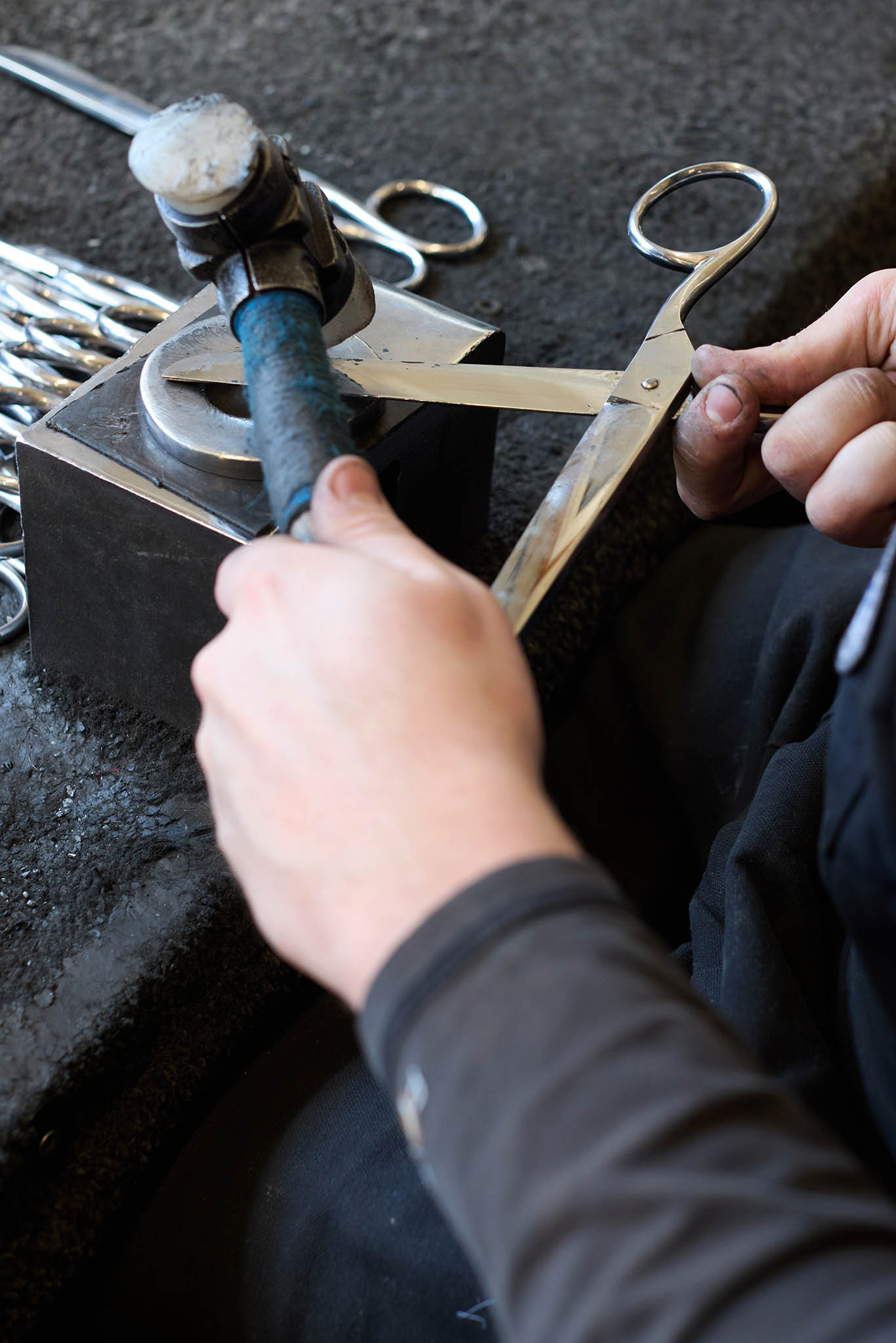 Ernest Wright hands working on pair of scissors hammer carbon steel