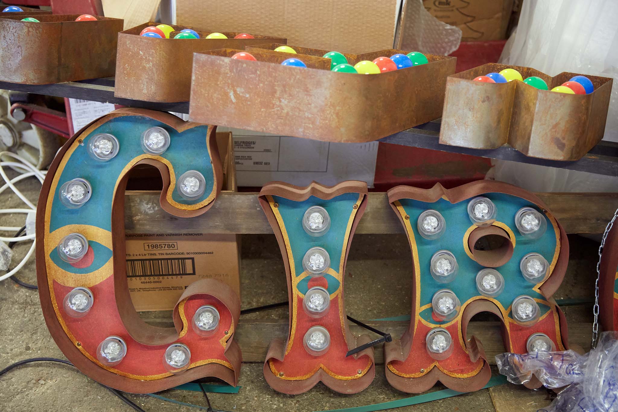 Electro Signs red and blue sign beginnings of work circus letters are filled with white light bulbs
