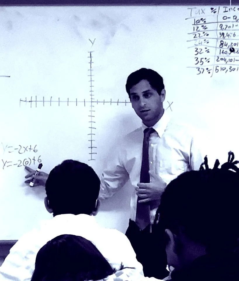 Man presenting in front of white board 