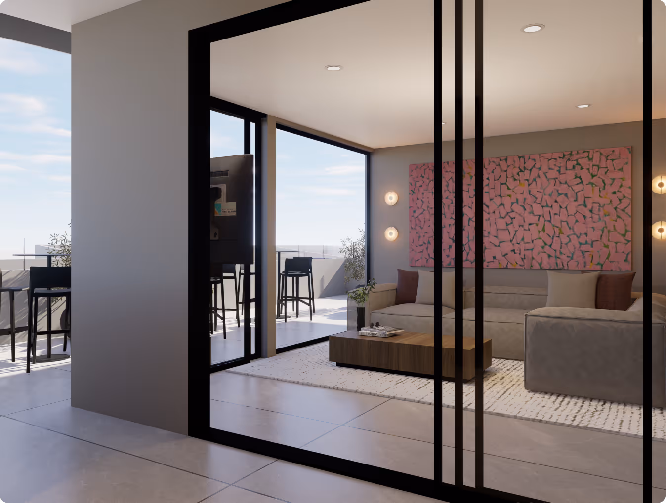 Modern living room with gray couches, a wooden coffee table, a large pink abstract painting, and floor-to-ceiling glass doors opening to an outdoor patio with high chairs.