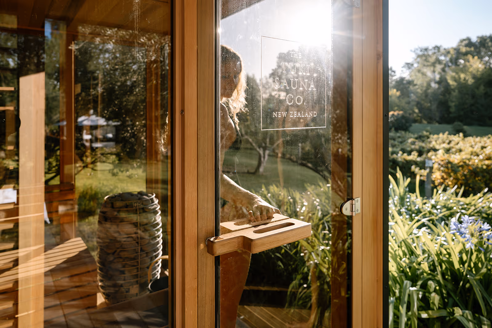 A girl walking into a sauna and closing the door