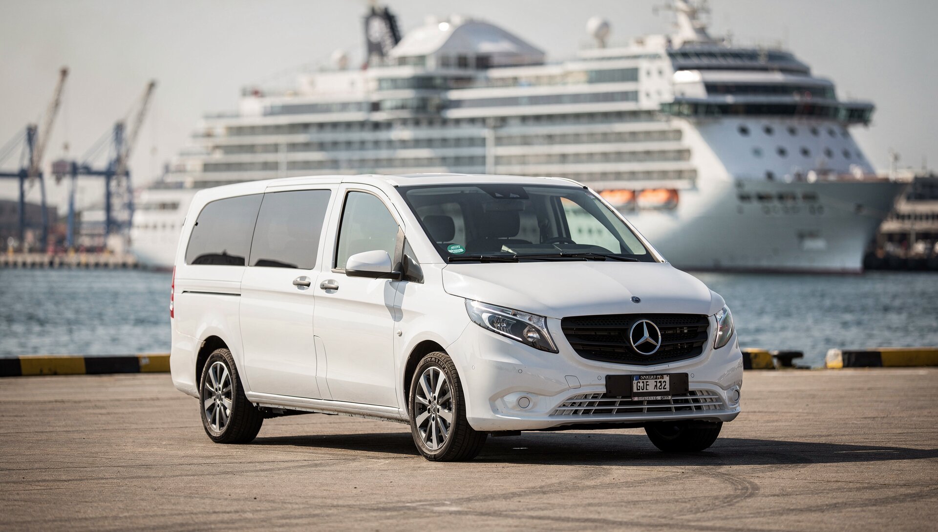Mercedes Vito port transfer vehicle with large cruise ship in background