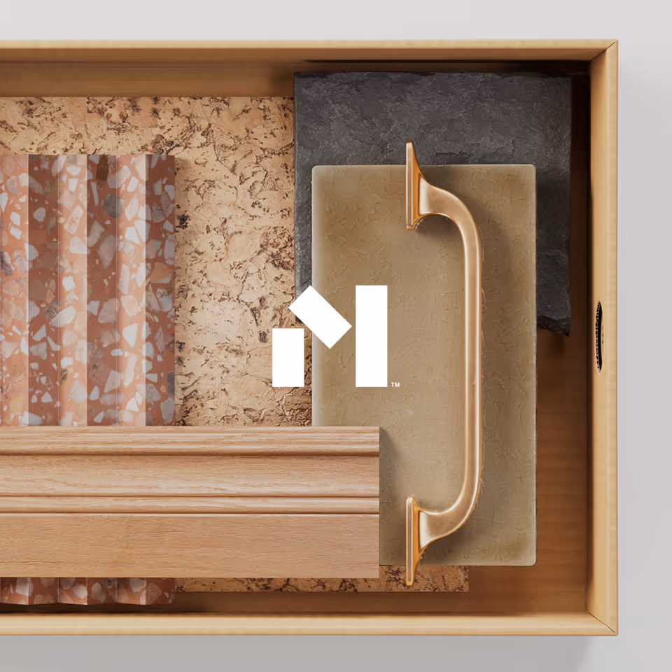 Wooden box containing samples of terrazzo, cork, textured stone, wood molding, and a brass cabinet handle.